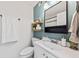 Bathroom featuring a modern vanity, toilet, stylish lighting, and a light green accent wall at 12 Palmetto Park Dr, Charleston, SC 29407