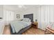 Bright bedroom with a cozy bed, wood floors, and soft natural light through sheer curtains at 12 Palmetto Park Dr, Charleston, SC 29407