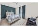 Bedroom with a blue accent wall, patterned bedding, and soft carpet flooring at 12 Palmetto Park Dr, Charleston, SC 29407
