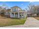 Well-maintained two-story home with a cozy front porch and a neatly kept lawn at 12 Palmetto Park Dr, Charleston, SC 29407