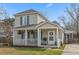 Charming two-story home featuring a welcoming front porch and lush green lawn at 12 Palmetto Park Dr, Charleston, SC 29407
