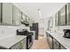Modern kitchen with granite countertops, stainless steel appliances, and shaker cabinets at 12 Palmetto Park Dr, Charleston, SC 29407