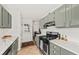Well-lit kitchen with stainless steel appliances, updated cabinetry, and granite countertops at 12 Palmetto Park Dr, Charleston, SC 29407