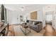 Inviting living room featuring a comfortable gray sofa, wood floors, and natural light at 12 Palmetto Park Dr, Charleston, SC 29407