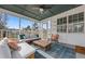Cozy screened-in porch with comfortable seating, a wooden table, and an outdoor view at 12 Palmetto Park Dr, Charleston, SC 29407