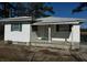 Cozy single-story home featuring white siding, a covered front porch, and a metal roof, surrounded by a chainlink fence at 1202 Forty-One Rd, Saint Stephen, SC 29479
