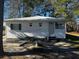 Quaint home with white siding, green shutters, and metal roof, nestled in a serene, tree-lined neighborhood at 1202 Forty-One Rd, Saint Stephen, SC 29479