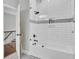 Modern bathroom with tub and glass shower, white tile, and unique floor design at 1208 Red Buckeye Ct, Moncks Corner, SC 29461