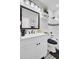 Updated bathroom with dark fixtures, floating shelves, and gray accent stripe at 1208 Red Buckeye Ct, Moncks Corner, SC 29461