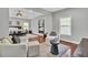 Bedroom featuring hardwood floors, sitting area, tray ceilings with modern light fixture and lots of natural light at 1208 Red Buckeye Ct, Moncks Corner, SC 29461