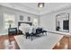 Bedroom with hardwood floors featuring large mirror, sitting area, tray ceilings and generous natural light at 1208 Red Buckeye Ct, Moncks Corner, SC 29461