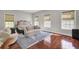 Bright bedroom with hardwood floors, three windows, decorative accents, and neutral tones at 1208 Red Buckeye Ct, Moncks Corner, SC 29461