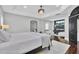 Bedroom has hardwood floors, a fireplace, sitting area and tray ceiling with modern light fixture at 1208 Red Buckeye Ct, Moncks Corner, SC 29461