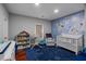 Bright Bedroom with blue walls and a playful world map at 1208 Red Buckeye Ct, Moncks Corner, SC 29461