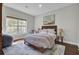 Cozy bedroom features a comfortable bed, window, area rug, and a calm, relaxing aesthetic at 1208 Red Buckeye Ct, Moncks Corner, SC 29461
