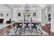 Elegant dining room with modern chandelier, trim detail, and hardwood floors at 1208 Red Buckeye Ct, Moncks Corner, SC 29461