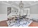 Elegant dining room with modern chandelier, trim detail, and hardwood floors at 1208 Red Buckeye Ct, Moncks Corner, SC 29461