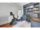 Bright home gym space with built in bookshelves and desk, and Peloton at 1208 Red Buckeye Ct, Moncks Corner, SC 29461
