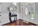 Inviting foyer with hardwood floors, elegant millwork, and decorative table at 1208 Red Buckeye Ct, Moncks Corner, SC 29461