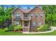Charming brick two-story home featuring a manicured lawn and lush landscaping at 1208 Red Buckeye Ct, Moncks Corner, SC 29461