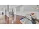 Bright hallway features hardwood floors, white wainscoting, and chair with modern lamp, and a decorative rug at 1208 Red Buckeye Ct, Moncks Corner, SC 29461