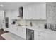 Well-appointed kitchen with modern stainless steel appliances, white cabinetry, and stylish tile backsplash at 1208 Red Buckeye Ct, Moncks Corner, SC 29461