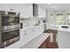 Bright kitchen featuring white cabinetry, stainless steel appliances, and hardwood floors at 1208 Red Buckeye Ct, Moncks Corner, SC 29461
