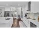 Bright and open kitchen with a center island, stainless steel appliances, and modern white cabinetry at 1208 Red Buckeye Ct, Moncks Corner, SC 29461