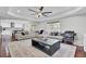 Bright living room featuring a large sectional sofa, coffered ceiling, and elegant area rug at 1208 Red Buckeye Ct, Moncks Corner, SC 29461