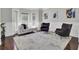 Bright living room with modern furnishings and lots of natural light from bay windows at 1208 Red Buckeye Ct, Moncks Corner, SC 29461
