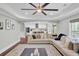 Open-concept living room with a comfortable sectional sofa and views into a bright, modern kitchen at 1208 Red Buckeye Ct, Moncks Corner, SC 29461