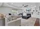 Cozy living room featuring a fireplace, built-in shelves, ceiling fan, and a neutral area rug at 1208 Red Buckeye Ct, Moncks Corner, SC 29461