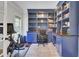 Home office space with floor to ceiling shelving, hardwood floors, and natural light at 1208 Red Buckeye Ct, Moncks Corner, SC 29461