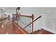 Wood staircase with decorative wrought iron spindles and wood railing at 1208 Red Buckeye Ct, Moncks Corner, SC 29461
