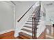 Traditional staircase with hardwood steps, black wrought iron spindles, and white risers at 1208 Red Buckeye Ct, Moncks Corner, SC 29461
