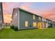 Backyard featuring a green lawn, screened in porch, and sunset sky at 121 Loon Dr, Summerville, SC 29483