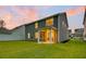 Backyard featuring a green lawn, screened in porch, and sunset sky at 121 Loon Dr, Summerville, SC 29483