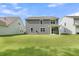 Manicured backyard featuring a well-maintained lawn and a screened in porch at 121 Loon Dr, Summerville, SC 29483