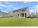 Spacious backyard featuring a lush lawn and screened in porch at 121 Loon Dr, Summerville, SC 29483