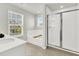 Bright bathroom with a soaking tub, walk-in shower, and a large vanity with neutral tile flooring at 121 Loon Dr, Summerville, SC 29483