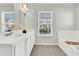 Bathroom featuring dual sinks, tile floors, and a soaking tub with a wooden bath caddy at 121 Loon Dr, Summerville, SC 29483