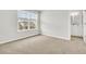 Bright bedroom featuring neutral carpet, a large window, and a view of the neighborhood at 121 Loon Dr, Summerville, SC 29483