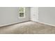 Bedroom featuring neutral carpet, a large window, and a double door closet at 121 Loon Dr, Summerville, SC 29483