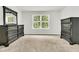 Spacious bedroom with carpet flooring, two dark wood dressers, and a bright window at 121 Loon Dr, Summerville, SC 29483