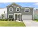 Charming two-story home with an attached garage, lush front lawn, and tidy landscaping at 121 Loon Dr, Summerville, SC 29483