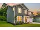 Side view of a two-story home featuring a manicured lawn, tidy landscaping, and an attached garage at 121 Loon Dr, Summerville, SC 29483
