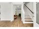 Bright foyer featuring hardwood floors, a staircase with wood and white trim, and a charming accent table at 121 Loon Dr, Summerville, SC 29483