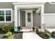 Inviting front porch with a well-manicured garden, walkway, and cozy curb appeal at 121 Loon Dr, Summerville, SC 29483