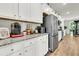 Kitchen features stainless steel refrigerator, granite counters, and modern coffee station on white cabinets at 121 Loon Dr, Summerville, SC 29483