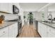 Well-equipped kitchen featuring stainless steel appliances, granite countertops, white cabinets, and an adjacent dining area at 121 Loon Dr, Summerville, SC 29483